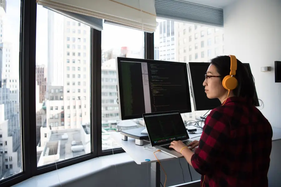 Developer working across multiple monitors